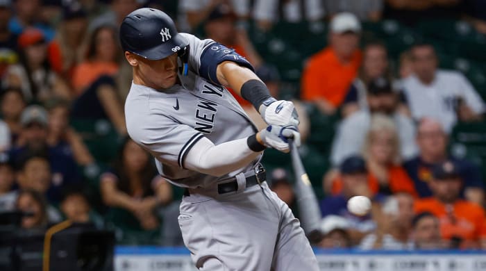 Jul 21, 2022; Houston, Texas, USA; New York Yankees designated hitter Aaron Judge (99) hits a three-run home run during the ninth inning against the Houston Astros at Minute Maid Park.
